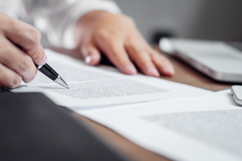 Insurance agent checking policy documents in office